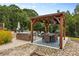 Outdoor living space with a pergola, dining table, sofa, and chairs overlooking a pool at 127 Tradition Ln, Mooresville, NC 28115