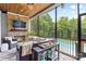 Cozy screened porch with fireplace, TV, seating, and views of the pool at 127 Tradition Ln, Mooresville, NC 28115