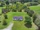 An aerial view of the home surrounded by lush greenery, trees, and open fields, offering privacy and space at 131 Sam Smith Rd, Kings Mountain, NC 28086