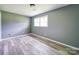 Cozy bedroom with bright light, neutral paint, and wood-look flooring at 131 Sam Smith Rd, Kings Mountain, NC 28086