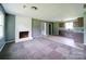 Open-concept living room with fireplace flowing into a kitchen space with ample countertop space at 131 Sam Smith Rd, Kings Mountain, NC 28086