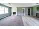 Open-concept living room with a painted fireplace and a view into the kitchen area at 131 Sam Smith Rd, Kings Mountain, NC 28086