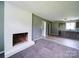 Open-concept living room featuring a painted brick fireplace and open doorway at 131 Sam Smith Rd, Kings Mountain, NC 28086