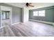 Bright living room with wood-look floors, a brick accent wall, and ample natural light at 131 Sam Smith Rd, Kings Mountain, NC 28086