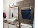 Bathroom with dark tile, modern vanity, and pebble countertop at 5601 Indian Brook Dr, Matthews, NC 28104