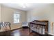 Charming bedroom with hardwood floors and crib at 5601 Indian Brook Dr, Matthews, NC 28104