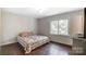 Bright bedroom with hardwood floors and large window at 5601 Indian Brook Dr, Matthews, NC 28104