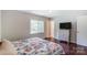 Bedroom with hardwood floors, window, and ensuite access at 5601 Indian Brook Dr, Matthews, NC 28104