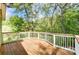 Wooden deck overlooking a lush, wooded backyard at 5601 Indian Brook Dr, Matthews, NC 28104