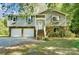 Gray two-story house with two-car garage, and landscaped yard at 5601 Indian Brook Dr, Matthews, NC 28104