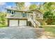 Gray house with two-car garage and a landscaped yard at 5601 Indian Brook Dr, Matthews, NC 28104