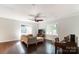 Bright living room with hardwood floors, comfortable seating, and a piano at 5601 Indian Brook Dr, Matthews, NC 28104