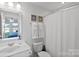 Light and bright bathroom with vanity, toilet, shower, and decor at 12119 Brooklyn Ave, Charlotte, NC 28204
