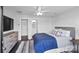 Bedroom showcasing neutral walls, dark wood floors, large windows, a ceiling fan, and access to a walk-in closet at 12119 Brooklyn Ave, Charlotte, NC 28204
