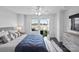Bright bedroom with a ceiling fan, neutral walls, and large windows that fill the room with natural light at 12119 Brooklyn Ave, Charlotte, NC 28204