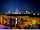 Night view of the illuminated Charlotte skyline from atop a modern multi-story residential building at 12119 Brooklyn Ave, Charlotte, NC 28204