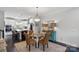 Elegant dining area features a glass table set, stylish lighting, and is adjacent to a modern kitchen at 12119 Brooklyn Ave, Charlotte, NC 28204