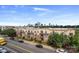 Three-story apartment complex with well-manicured landscaping and street parking at 12119 Brooklyn Ave, Charlotte, NC 28204