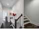 Hallway featuring a staircase with dark wood floors and a console table at 12119 Brooklyn Ave, Charlotte, NC 28204