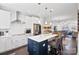Open concept kitchen with stainless steel appliances, a large island with bar seating and white cabinetry at 12119 Brooklyn Ave, Charlotte, NC 28204