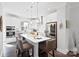 Kitchen featuring a large island with seating, white cabinetry, stainless steel appliances, and modern lighting at 12119 Brooklyn Ave, Charlotte, NC 28204