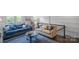 Cozy living room features hardwood floors, neutral paint, an upstairs loft, and modern decor at 12119 Brooklyn Ave, Charlotte, NC 28204