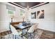 Elegant dining room with a modern table, chandelier, and wainscoting at 8611 Frank Grier Rd # 1, Charlotte, NC 28215