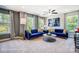 Loft with blue velvet sofa, coffee table, and ample natural light at 8611 Frank Grier Rd # 1, Charlotte, NC 28215