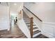 Wooden staircase with black metal balusters and dark hardwood floors at 8611 Frank Grier Rd # 1, Charlotte, NC 28215