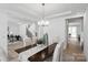 Bright dining area with modern lighting, hardwood floors, and views of the staircase and entryway at 5225 Glenwalk Dr # 0061, Charlotte, NC 28269