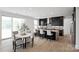 Modern kitchen with stainless steel appliances, island seating, and an adjacent dining area with sliding glass doors at 5225 Glenwalk Dr # 0061, Charlotte, NC 28269