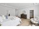 Bright main bedroom features a walk-in closet, a dresser with a round mirror, a queen size bed, and a sitting area at 5225 Glenwalk Dr # 0061, Charlotte, NC 28269