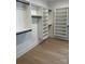 The spacious walk-in closet is equipped with custom shelves and black rods for organizing clothes at 5225 Glenwalk Dr # 0061, Charlotte, NC 28269