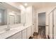 Modern bathroom with double vanity, white cabinets, and a large mirror at 1608 Cannonball Ln, Bessemer City, NC 28016