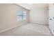 Bedroom with grey carpet and a window with blinds at 1608 Cannonball Ln, Bessemer City, NC 28016