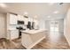 Open concept kitchen boasts white shaker cabinets, stainless steel appliances, and a large island at 1608 Cannonball Ln, Bessemer City, NC 28016