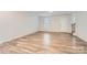 Bright living room features wood-look flooring and leads to an interior staircase at 1608 Cannonball Ln, Bessemer City, NC 28016
