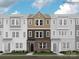 Three-story townhome with brick and siding exterior, multiple windows, and a front door at 4062 Skyboat Cir, Fort Mill, SC 29715