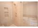 Bathroom with a large walk-in shower and a soaking tub at 147 Fesperman Cir, Troutman, NC 28166