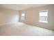 Large carpeted bedroom with two windows offering natural light at 147 Fesperman Cir, Troutman, NC 28166