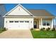 Inviting exterior of a charming single-story house with a two-car garage at 147 Fesperman Cir, Troutman, NC 28166