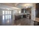 Modern kitchen featuring dark wood cabinets, stainless steel appliances, and granite countertops at 147 Fesperman Cir, Troutman, NC 28166