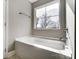 Bathroom featuring a large soaking tub and window at 822 N Rocky River Rd, Monroe, NC 28110