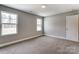 Spacious bedroom with neutral walls and carpet, featuring two large windows at 822 N Rocky River Rd, Monroe, NC 28110