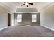 Primary bedroom with trey ceiling and carpet flooring at 822 N Rocky River Rd, Monroe, NC 28110