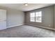 Spacious bedroom with carpet flooring and window at 822 N Rocky River Rd, Monroe, NC 28110