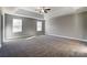 Bright bedroom with carpet, ceiling fan, and large windows at 822 N Rocky River Rd, Monroe, NC 28110