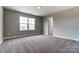 Bright bedroom with carpet flooring and a window at 822 N Rocky River Rd, Monroe, NC 28110