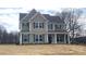 Two-story house with green and gray siding, and a covered front porch at 822 N Rocky River Rd, Monroe, NC 28110