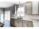Kitchen features granite countertops, white cabinets, and sliding glass doors to patio at 822 N Rocky River Rd, Monroe, NC 28110